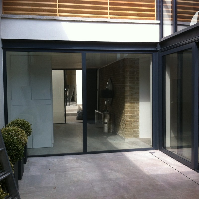 Floor-to-ceiling sliding doors opening to courtyard in Roehampton