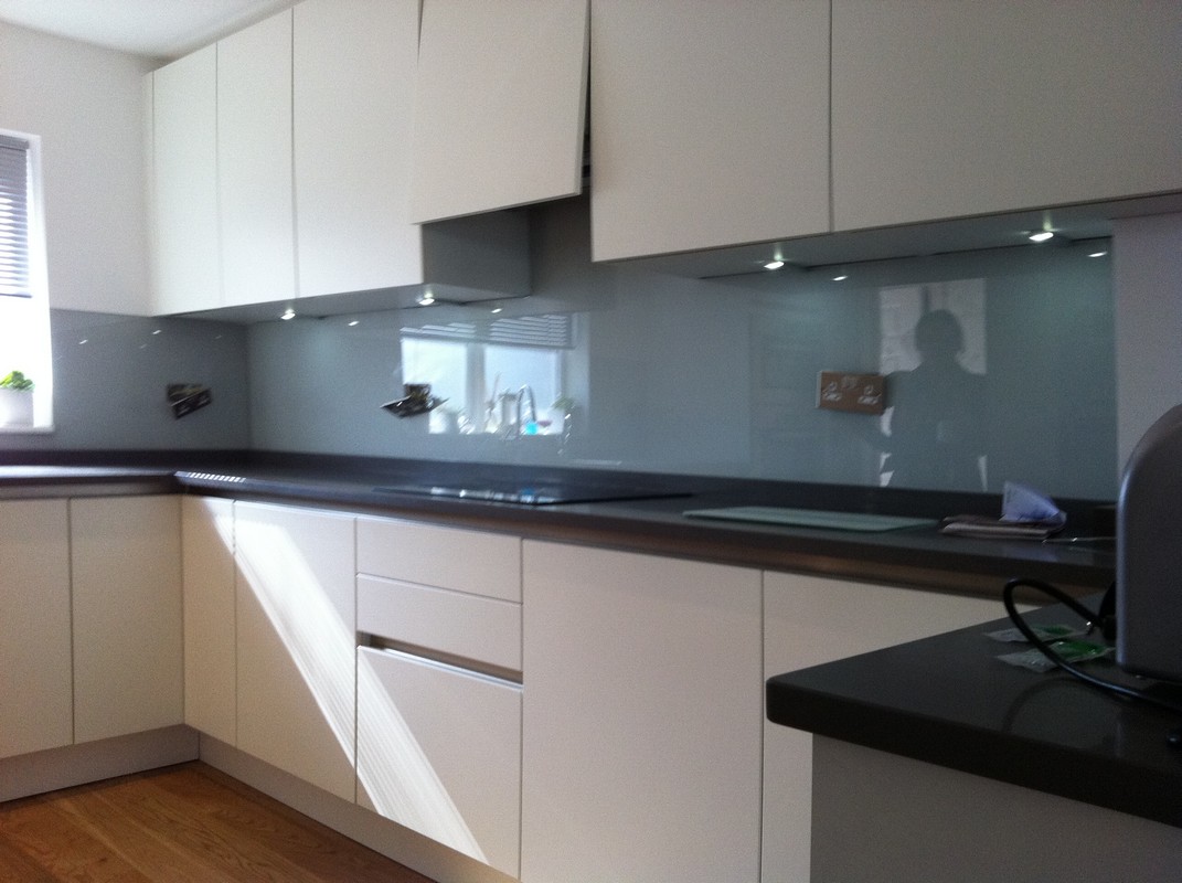 Grey glass kitchen splashback with LED lighting in Roehampton