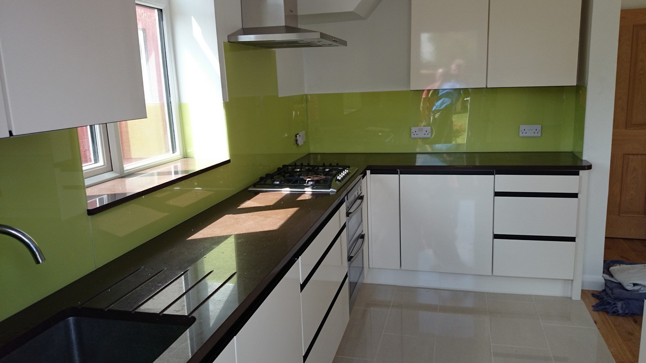 Lime green glass kitchen splashback installed by Roehampton glaziers