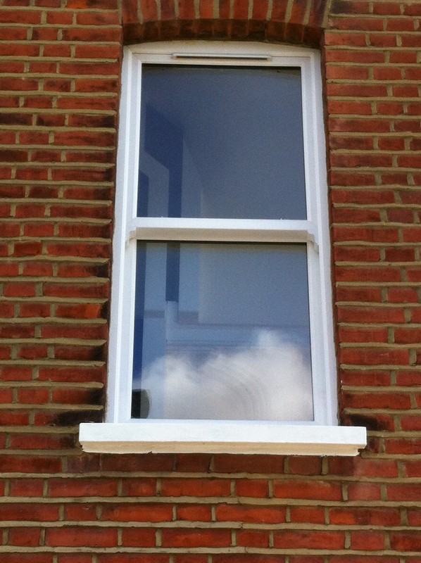 uPVC sash window on Victorian red brick house in Roehampton